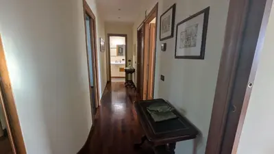 a hallway with a table in the middle of a room at Appia Nuova Lucrezia Apartment in Rome