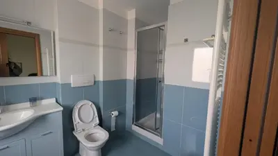 a bathroom with a toilet and a sink and a shower at Appia Nuova Lucrezia Apartment in Rome