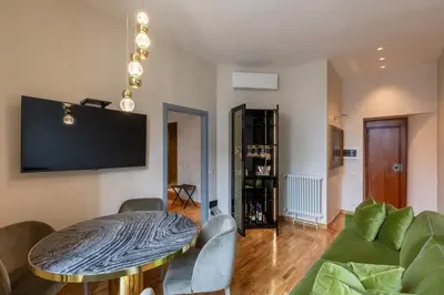 a living room with a table and a couch at Residenza Pierret in Rome