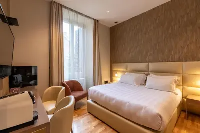 a hotel room with a bed and a television at Residenza Pierret in Rome