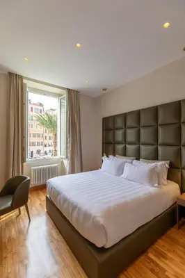 a bedroom with a large bed and a window at Residenza Pierret in Rome