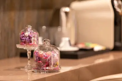 two glass jars filled with candy on a counter at Residenza Pierret in Rome