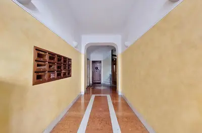 an empty hallway with yellow walls and a wine cellar at Monteverde family apartment in Rome