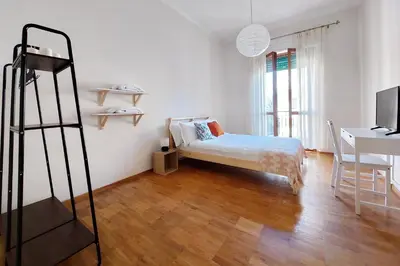 a bedroom with a bed and a desk and a ladder at Monteverde family apartment in Rome
