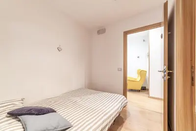 a bedroom with a bed and a chair at Ubaldi Luxury Rooms in Rome