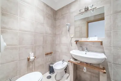 a bedroom with a bed and a flat screen tv at Ubaldi Luxury Rooms in Rome
