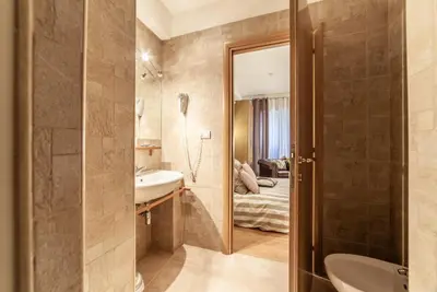 a bathroom with a sink and a mirror at Ubaldi Luxury Rooms in Rome