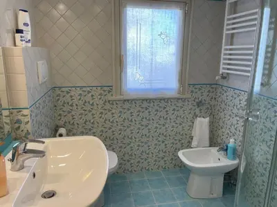 a bathroom with a sink and a toilet and a window at Trastevere Lenci House in Rome