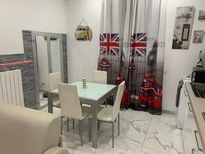 a dining room with a glass table and white chairs at Domus Felix Rome in Rome