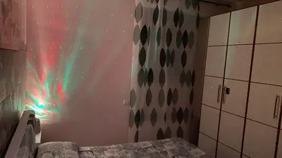 a bedroom with a wall with a display of the northern lights at Domus Felix Rome in Rome