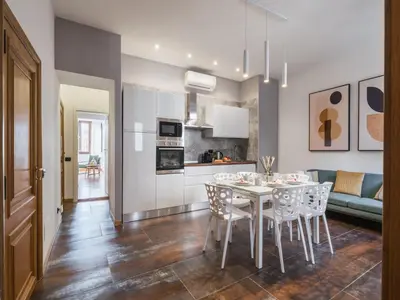 a kitchen and dining room with a table and chairs at The Best Rent - Three-bedroom apartment near Piazza Barberini in Rome