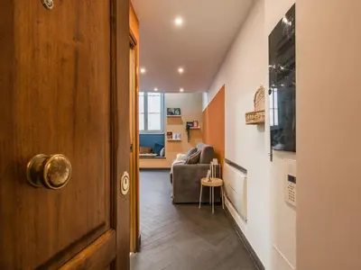a hallway with a living room with a couch at The Best Rent - Colorful loft in Trastevere area in Rome