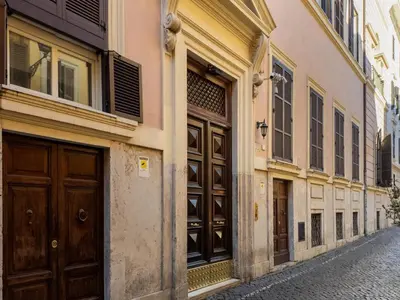 an alley with brown doors on a building at The Best Rent - Colorful loft in Trastevere area in Rome