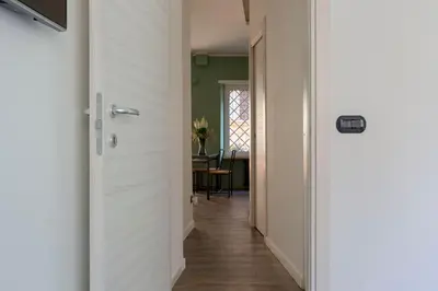 a hallway with a door leading to a dining room at Domus Rinascimento (Piazza Navona) in Rome