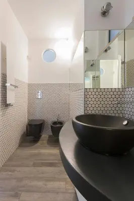 a bathroom with two toilets and a black sink at Domus Rinascimento (Piazza Navona) in Rome