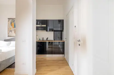 a white hallway with a kitchen in a bedroom at Saturno in Trevi in Rome
