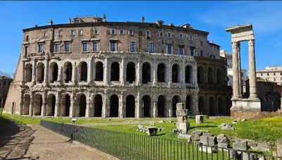 an old building with columns in front of it at Marcello Apartament in Rome
