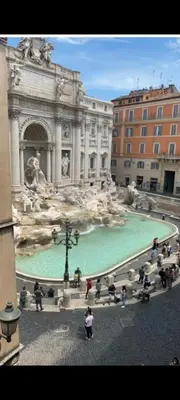 a group of people sitting around a fountain in a building at Marcello Apartament in Rome