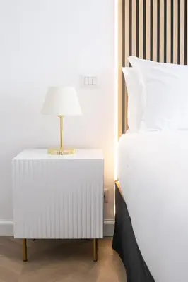 a bedroom with a bed and a nightstand with a lamp at Vatican City Apartment in Rome