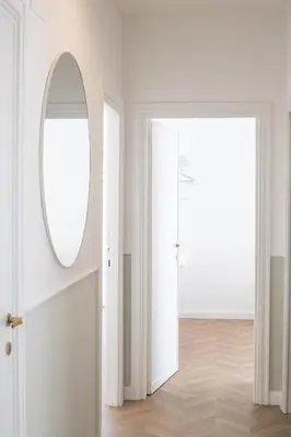 a white room with a mirror and a door at Vatican City Apartment in Rome