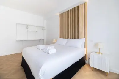 a bedroom with a large bed with white sheets at Vatican City Apartment in Rome