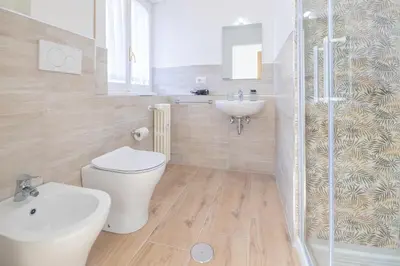 a bathroom with a toilet and a sink and a shower at Vatican City Apartment in Rome