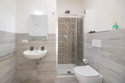 a bathroom with a toilet and a sink and a shower at Vatican City Apartment in Rome