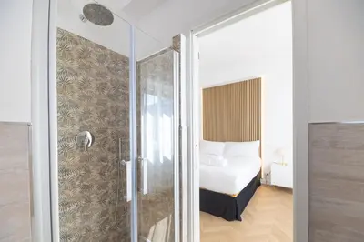 a bathroom with a shower and a bed in a room at Vatican City Apartment in Rome