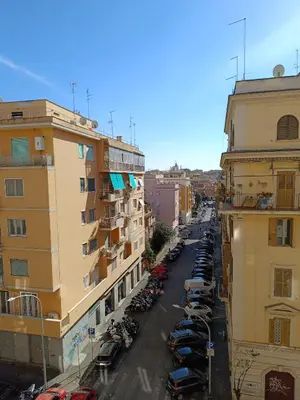 a city street with parked cars and buildings at Gay House Roma - Only Gay in Rome