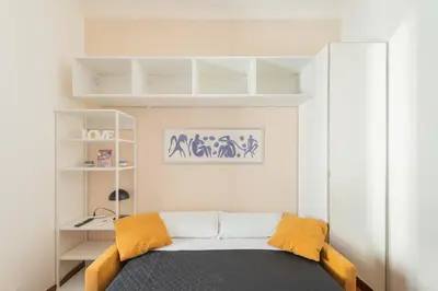 a small room with a bed and shelves at AppleMoon2.0 in Rome