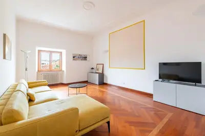 a living room with a couch and a flat screen tv at AppleMoon2.0 in Rome