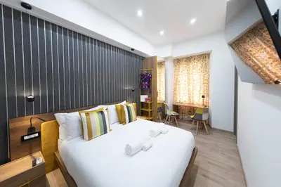 a bedroom with a large white bed in a room at Cola Suites Apartments in Rome