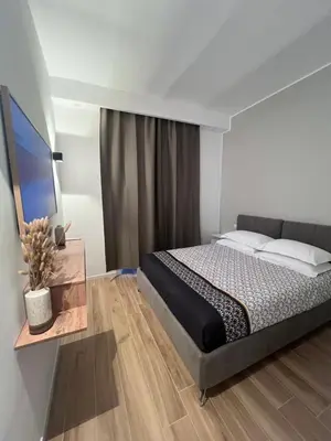 a bedroom with a large bed and a table at Palestro 78 in Rome