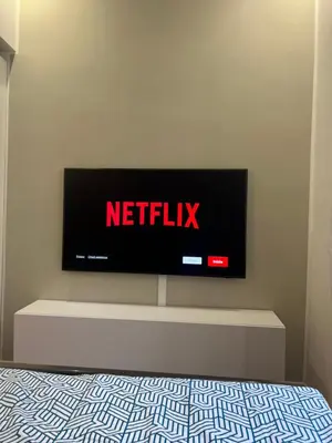 a television sitting on a wall in a bedroom at Palestro 78 in Rome
