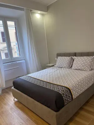 a bedroom with a large bed with a window at Palestro 78 in Rome