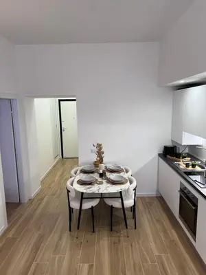 a white kitchen with a table in a room at Palestro 78 in Rome