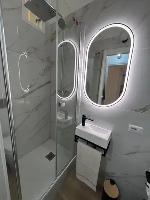a bathroom with a shower and a sink and a mirror at Palestro 78 in Rome