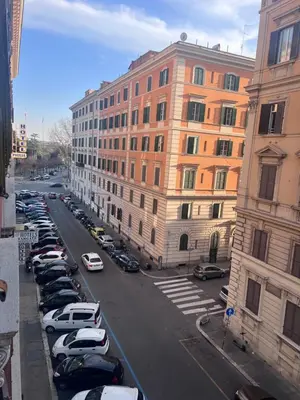 a city street with cars parked in a parking lot at Palestro 78 in Rome