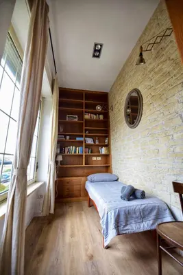 a bedroom with two beds and a brick wall at Industrial Loft Trastevere Station in Rome