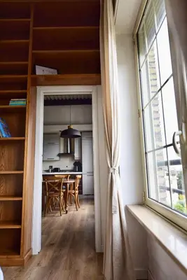 a kitchen and dining room with a large window at Industrial Loft Trastevere Station in Rome