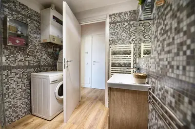 a bathroom with a washer and dryer in a room at Industrial Loft Trastevere Station in Rome