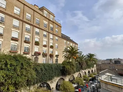 a large building with plants on the side of it at Industrial Loft Trastevere Station in Rome