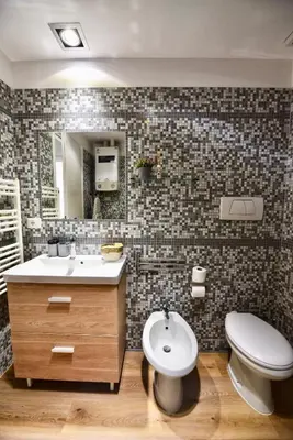 a bathroom with a sink and a toilet and a mirror at Industrial Loft Trastevere Station in Rome