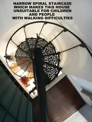 a spiral stair case with a window spiral staircase which makes this house unforgettable for children at Grottino 3a Apartment in Rome