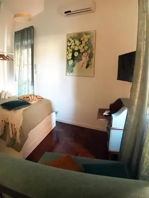 a bedroom with a bed and a desk and a television at Grottino 3a Apartment in Rome