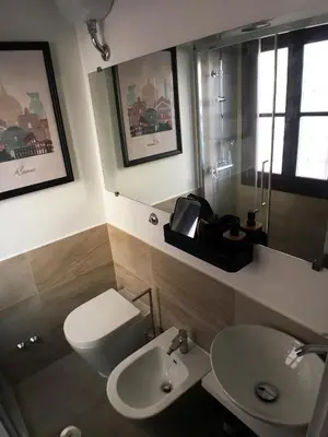 a bathroom with a toilet and a sink at Grottino 3a Apartment in Rome