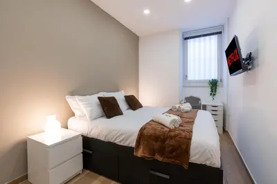 a bedroom with a bed and a tv on a wall at PL Guest House in Rome
