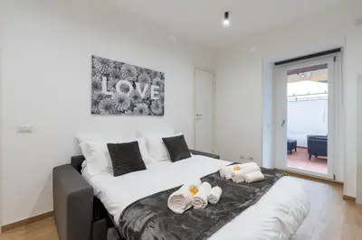 a bedroom with a large white bed with towels on it at PL Guest House in Rome