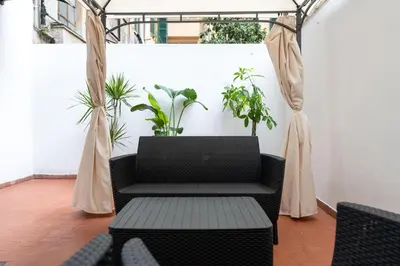 a patio with a table and chairs and plants at PL Guest House in Rome