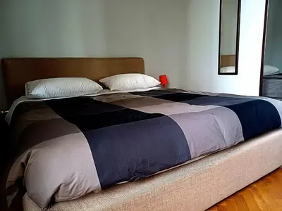 a large bed with a blue and brown blanket at La Casetta di Miriam a Piazza di Spagna in Rome